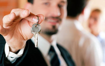 Image of man handing over a key